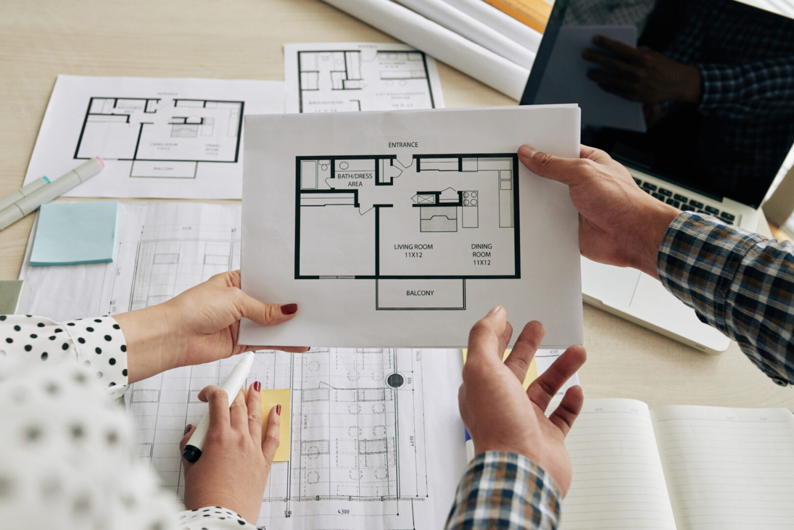 Architects discussing plan of the house at meeting